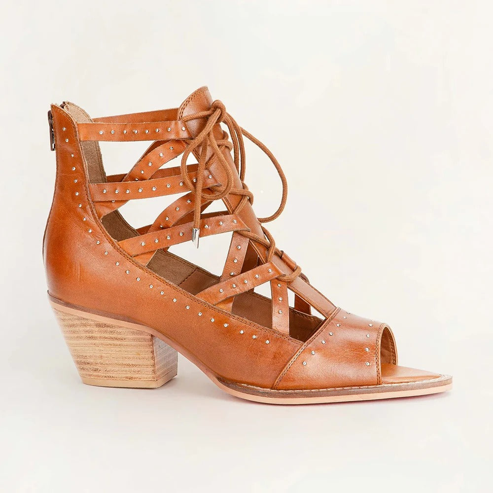Lace Up Booties In Calfskin from House of Hide in brown calfskin leather with lace-up design being displayed on light beige background