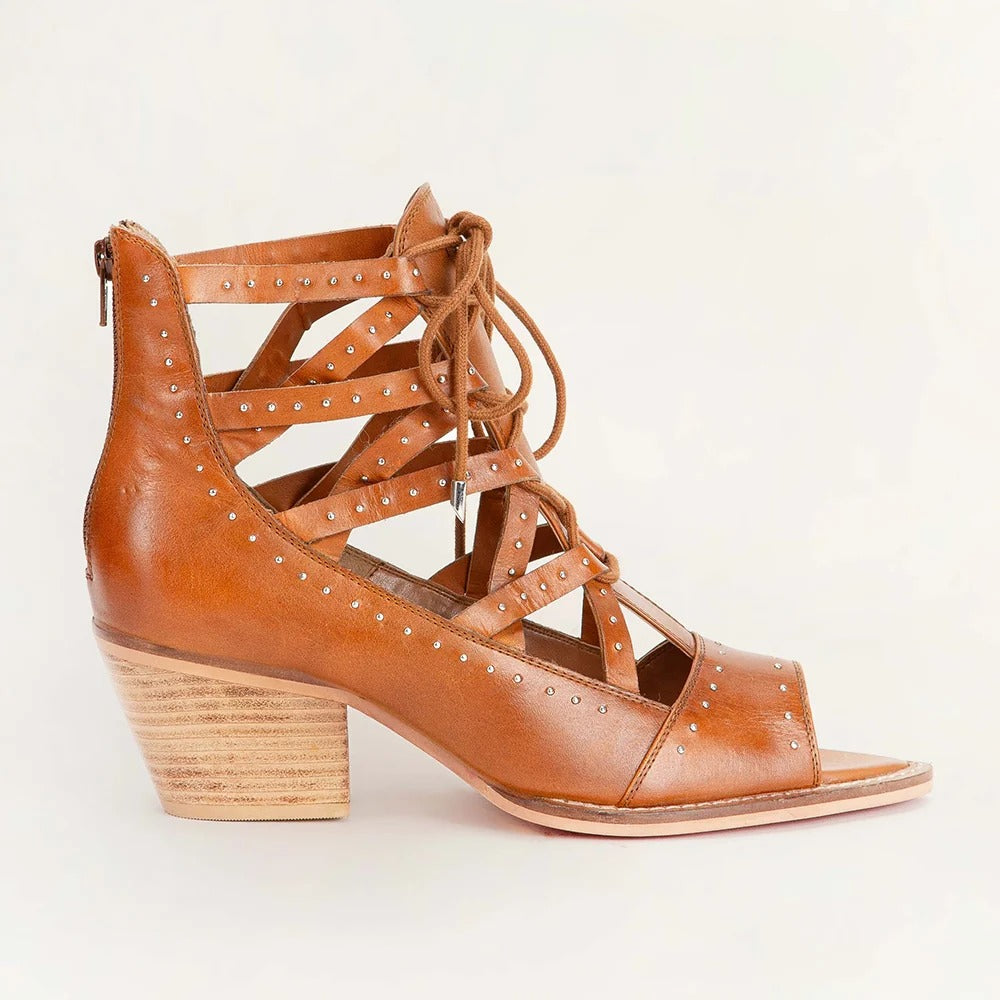 Lace Up Booties In Calfskin from House of Hide in brown calfskin leather with studded details being displayed on light beige background