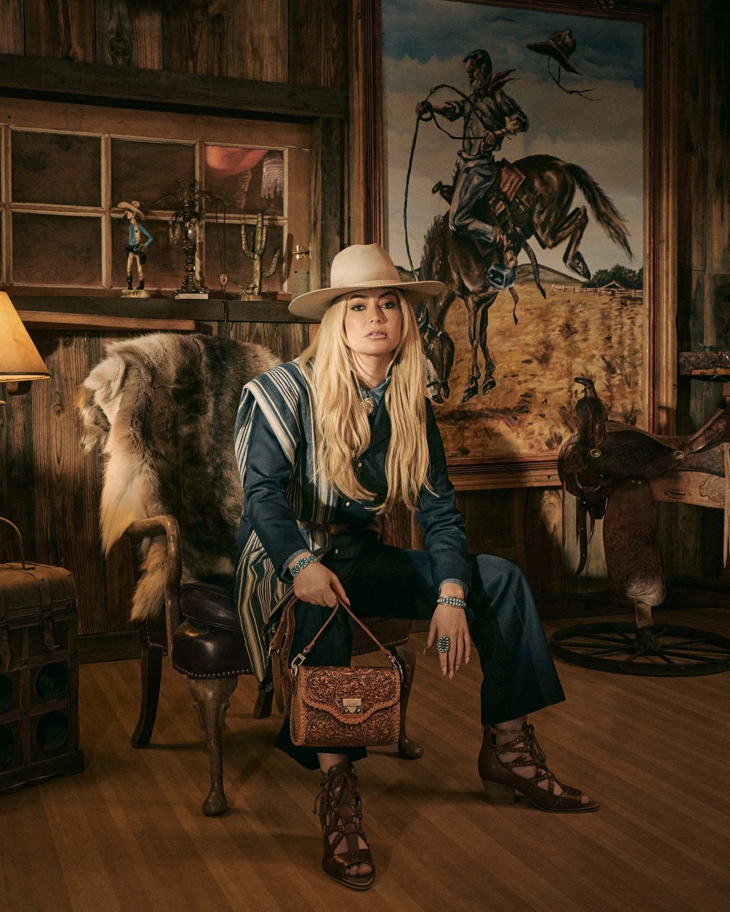 Lace Up Booties In Calfskin from House of Hide in brown calfskin leather with lace-up heeled strappy design being worn by model in cowboy hat in rustic western interior setting
