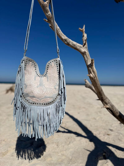 Light blue fringe handbag with tassels, perfect for cool summer skin tones and a boho-chic look.