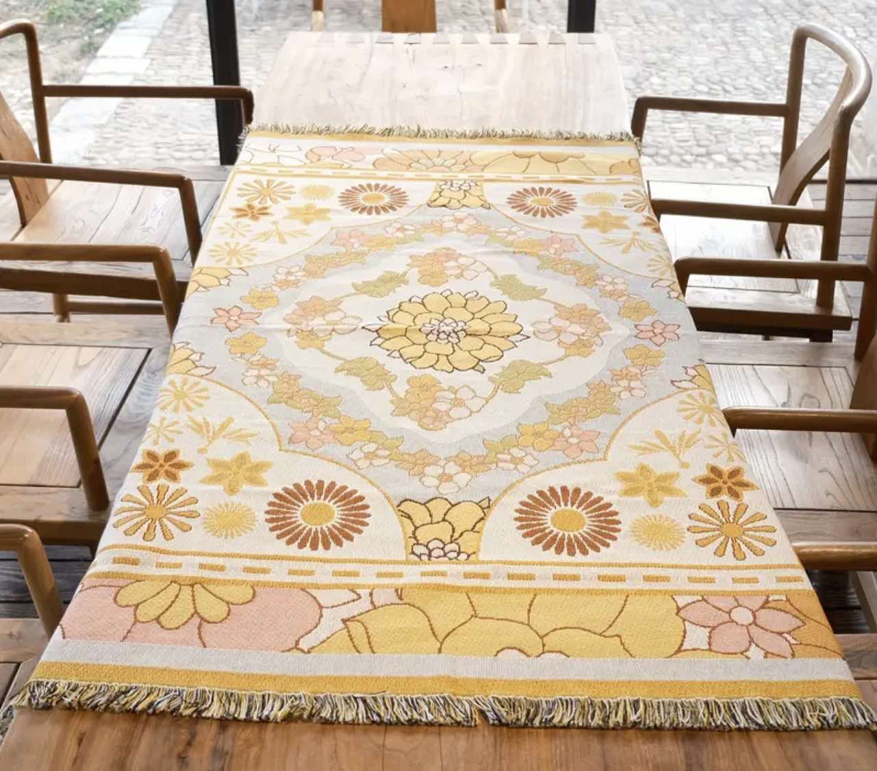Lightweight and durable Golden Glow Boho Rug used as a beach picnic blanket with intricate floral designs.