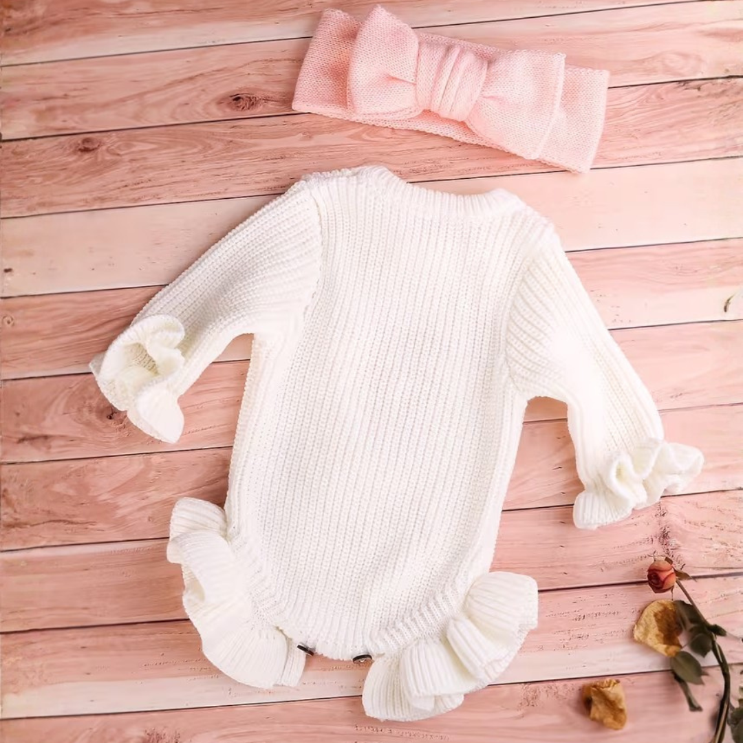 Little Darling Knit Romper Set from House of Hide in white ribbed knit with ruffled edges and pink she's here embroidery with bow detail being displayed as coordinated two-piece set in woven basket