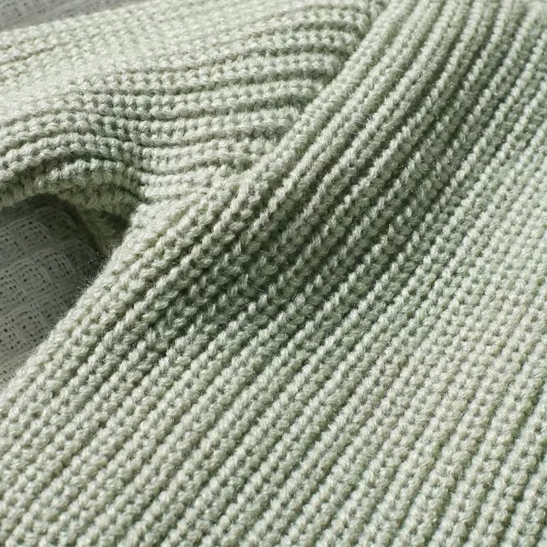 Little Wrangler Knit Romper Set from House of Hide in light sage green ribbed knit being displayed in close-up showing detailed yarn pattern and fabric folds