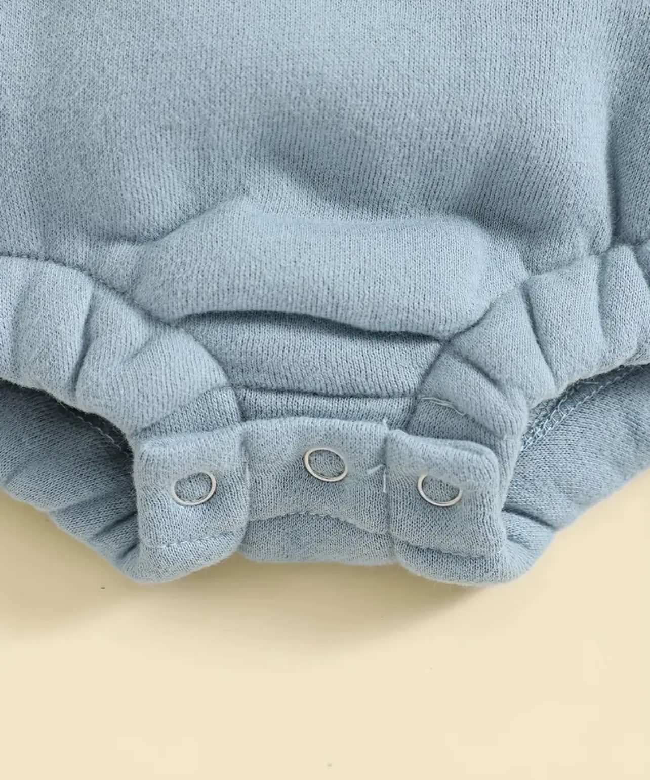 Long-sleeve ‘Little Dude’ romper in blue, soft and breathable with snap buttons.