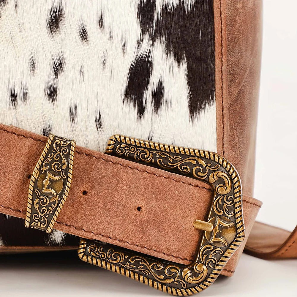 House of Hide genuine leather brown belt featuring a gold-tone buckle displayed on a cowhide patterned background