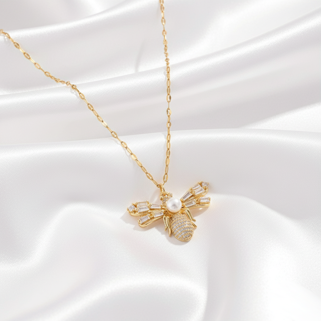 Luna Bee Necklace displayed on neutral background, highlighting bee pendant and refined gold craftsmanship.
