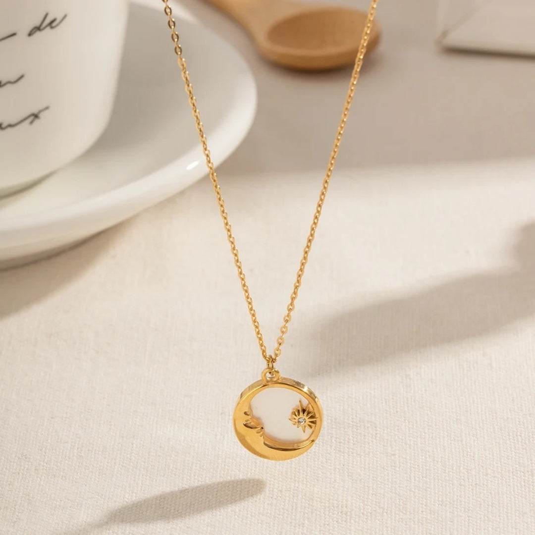 Gold moon pendant necklace by House of Hide Perth displayed on neutral light surface