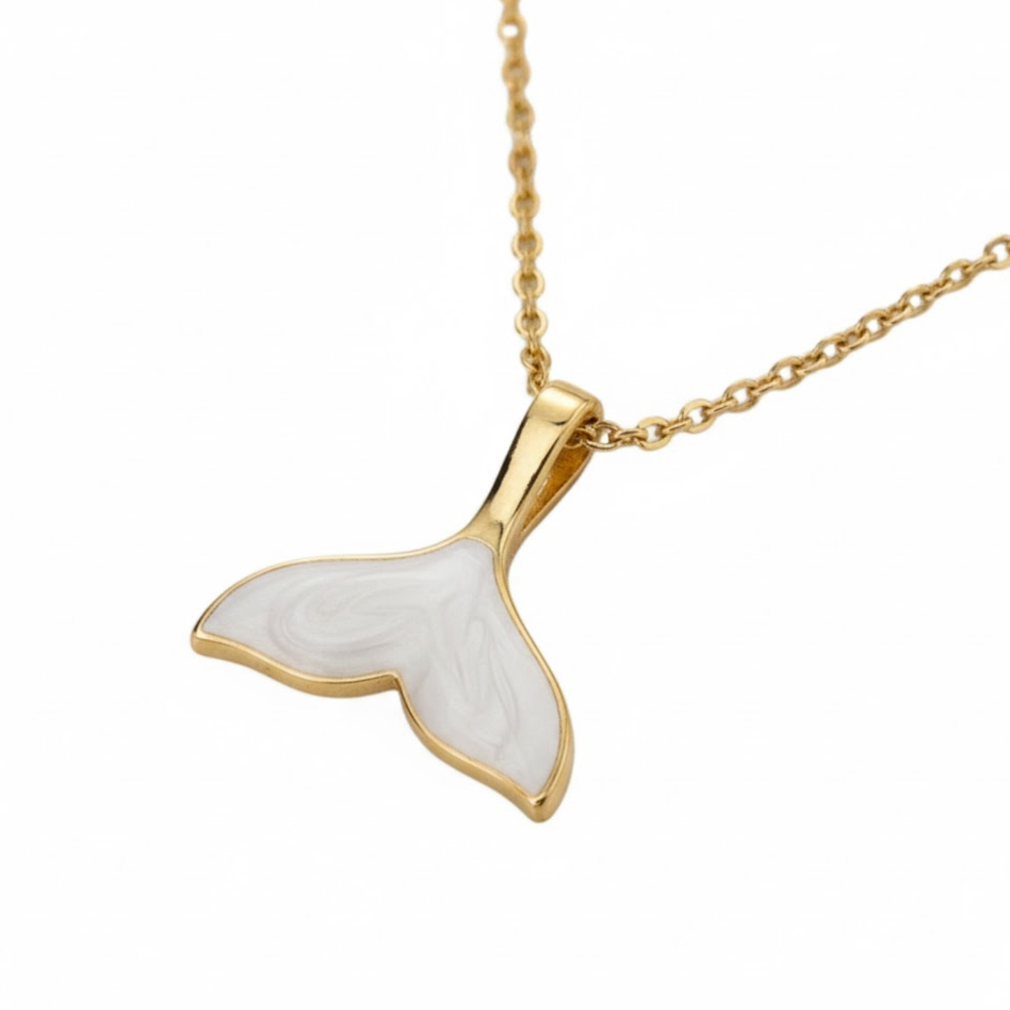 Close-up of the Maravéa Charm Necklace featuring a gold whale tail pendant with pearlescent white inlay.
