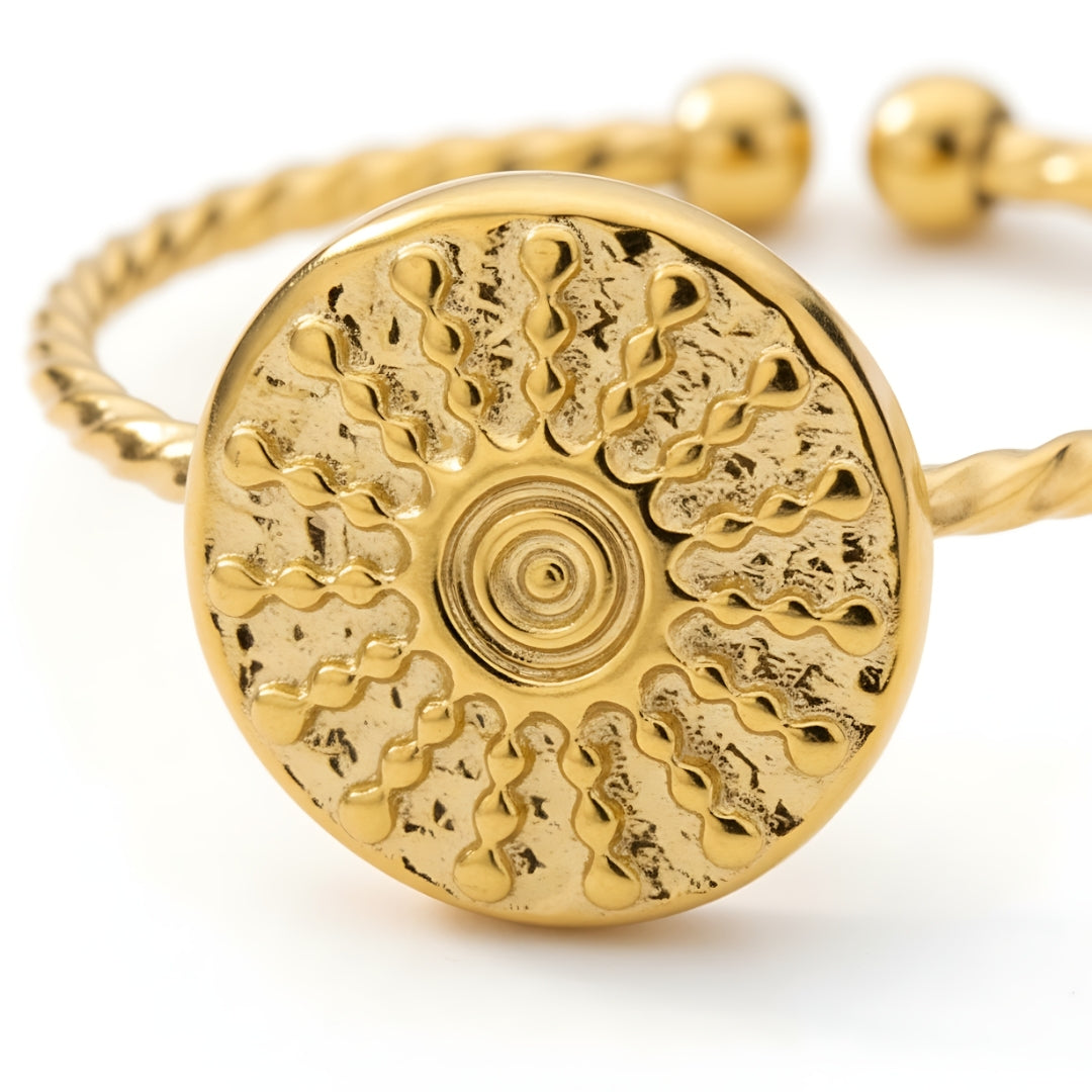 Close-up of the Marigold Mirage Ring featuring a bold gold-plated hammered disc with sunbeam-inspired concentric patterns.