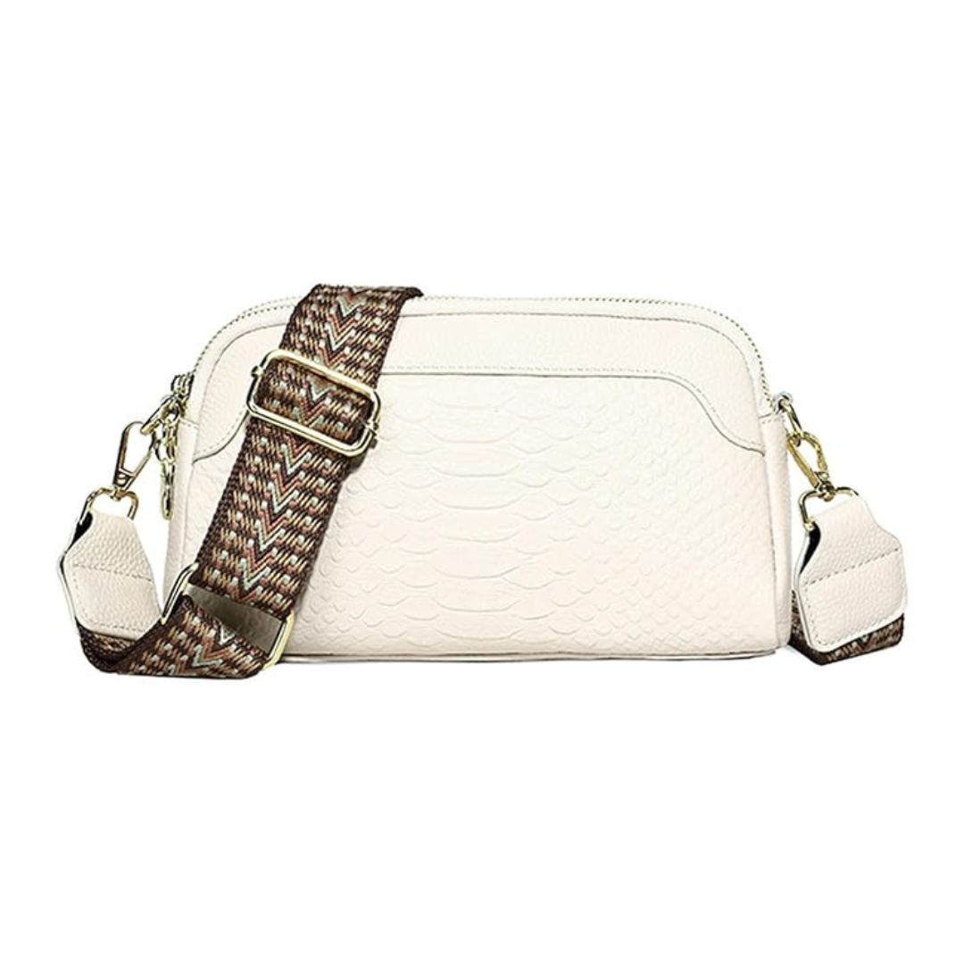 An off-white faux-snakeskin shoulder bag with a patterned brown and beige woven strap and gold-tone hardware, shown against a plain white background.