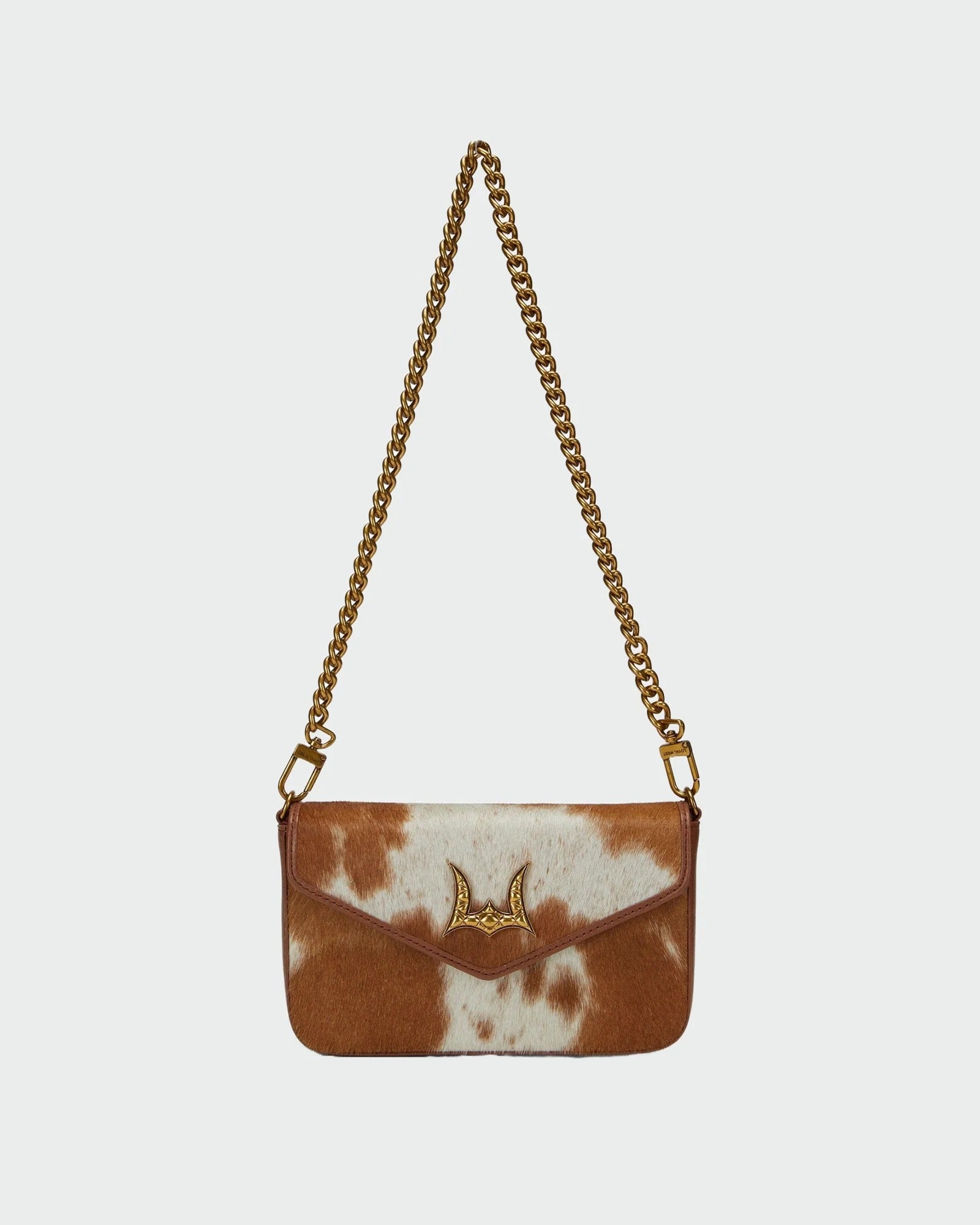 House of Hide genuine leather brown and white tie-dye patterned handbag featuring a gold-tone chain strap on a light gray studio background