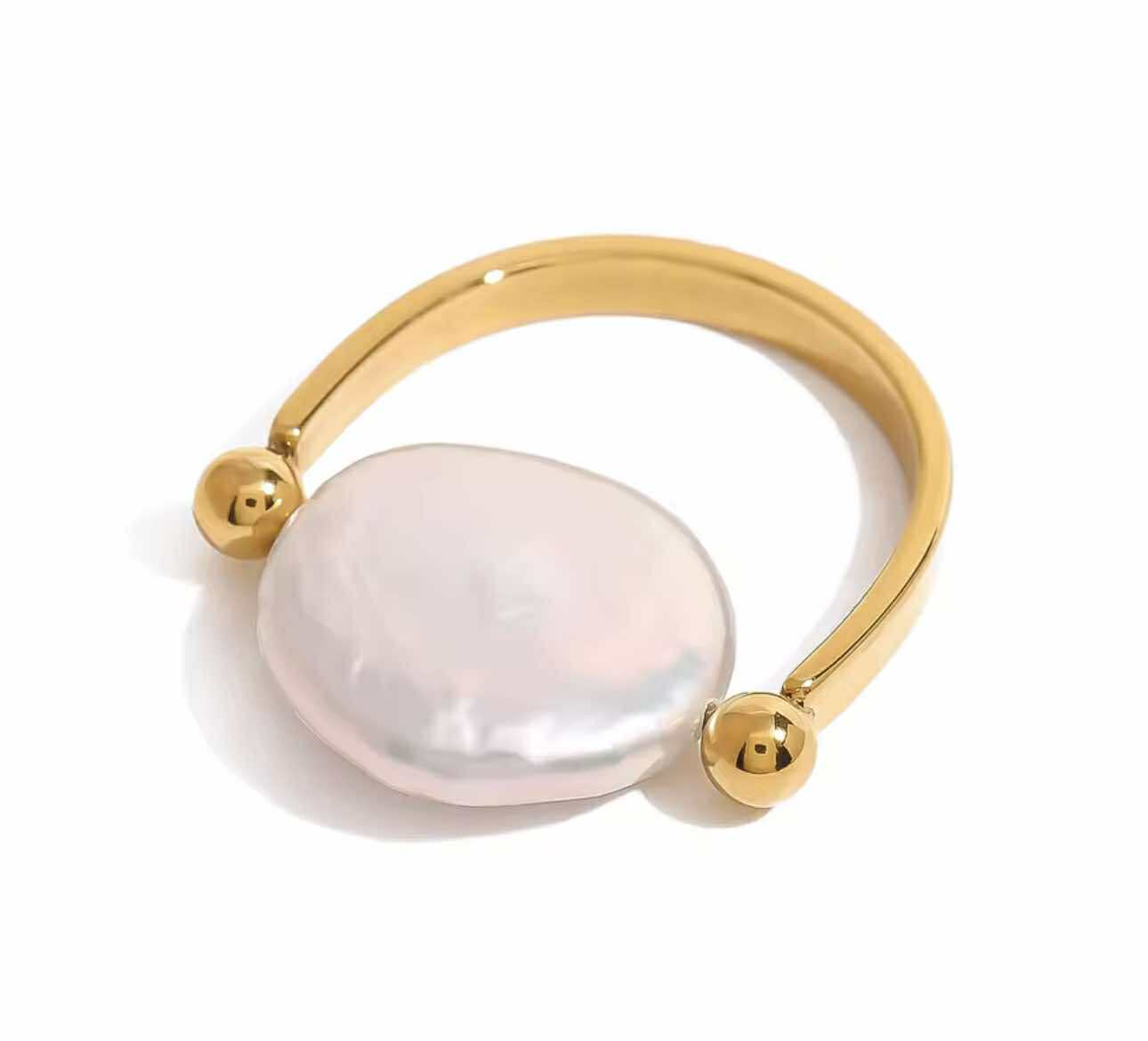 Minimal gold ring with freshwater pearl, perfect for stacking and made from tarnish-free stainless steel.