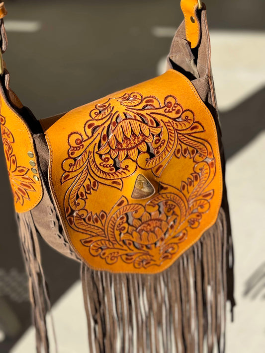 Montana hand-tooled leather crossbody bag with intricate designs and suede fringe, crafted from genuine antique brown leather.