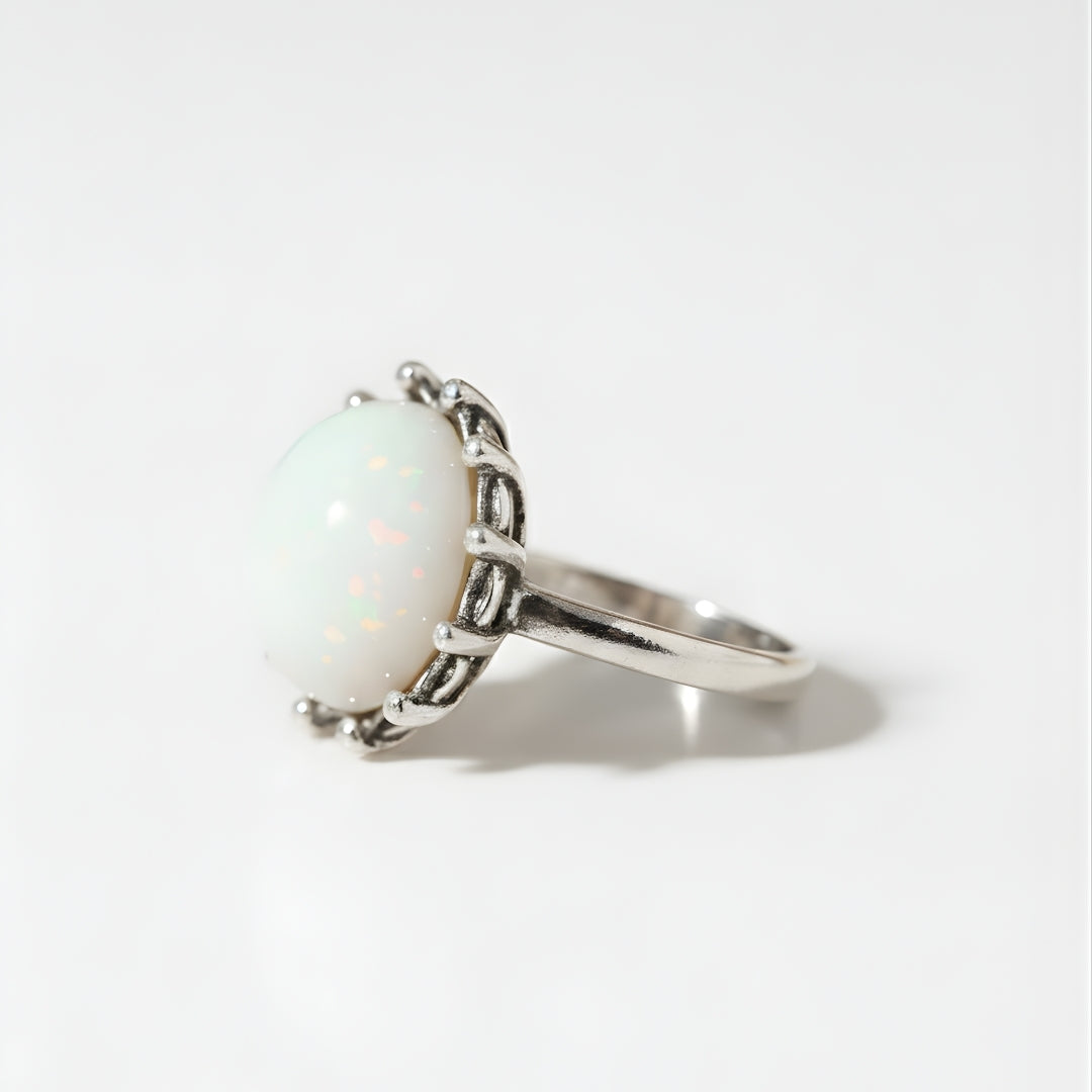 Moonstone Elegance Ring with luminous opal centerpiece on neutral beige backdrop