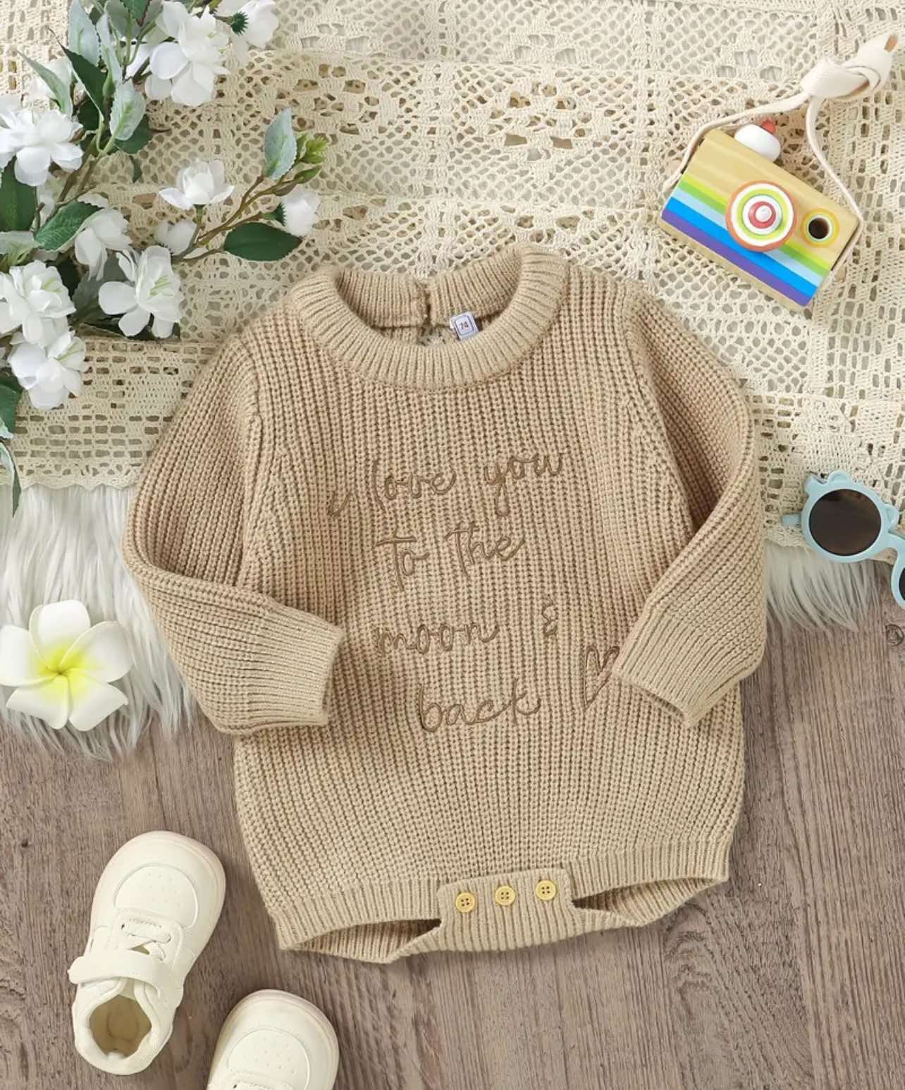 Neutral beige knit baby romper with 'Love You to the Moon & Back' embroidery, featuring soft cotton fabric, short sleeves, and button closure—perfect for Australian newborns and toddlers.