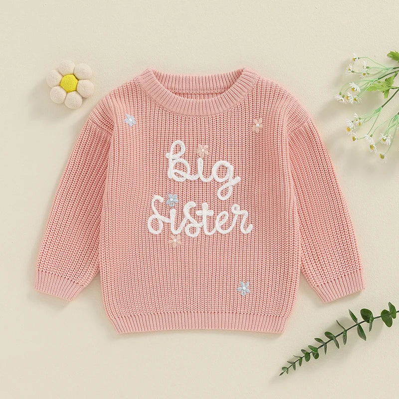 Flat lay of pink Big Sister knit jumper for toddler girls