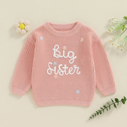 Flat lay of pink Big Sister knit jumper for toddler girls