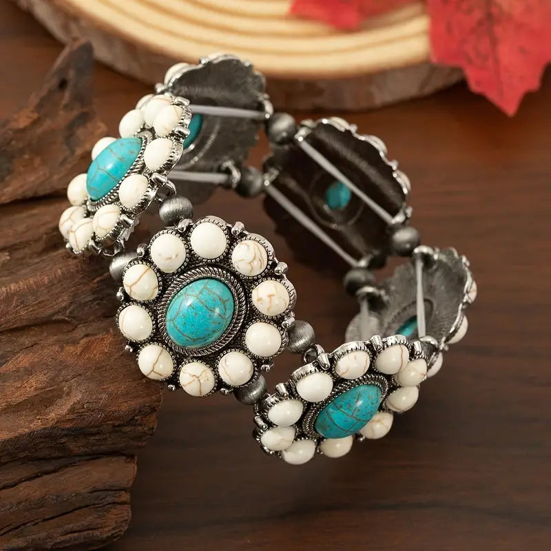 Rodeo bracelet Australia, antique-silver cuff with floral clusters and oval stones in white or turquoise for Western-inspired elegance.