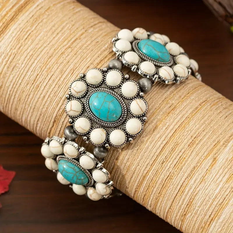Rodeo bracelet Australia, antique-silver cuff with floral clusters and oval stones in white or turquoise for Western-inspired elegance.