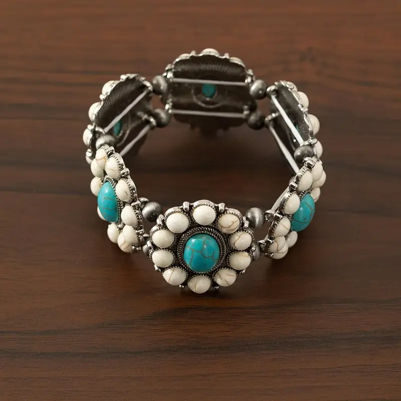 Rodeo bracelet Australia, antique-silver cuff with floral clusters and oval stones in white or turquoise for Western-inspired elegance.