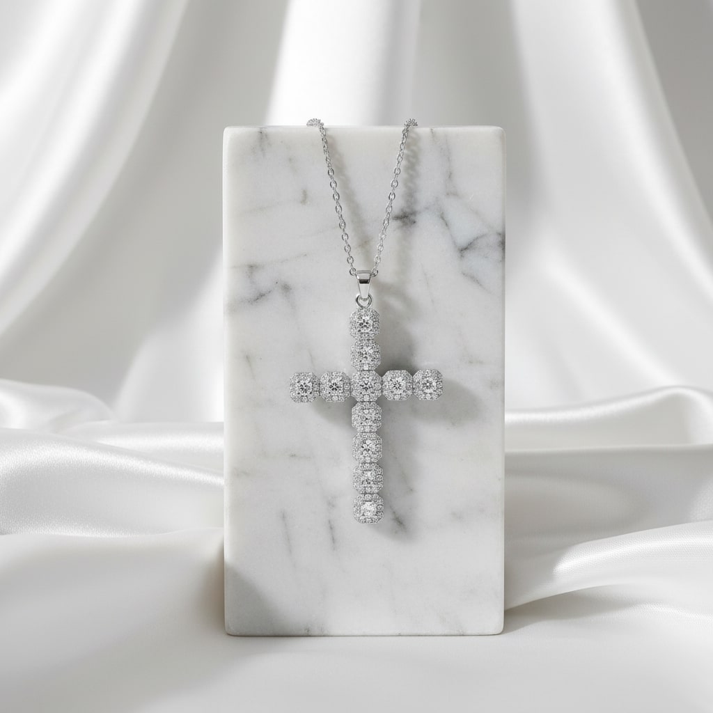 Minimalist silver cross pendant photographed on a clean beige background