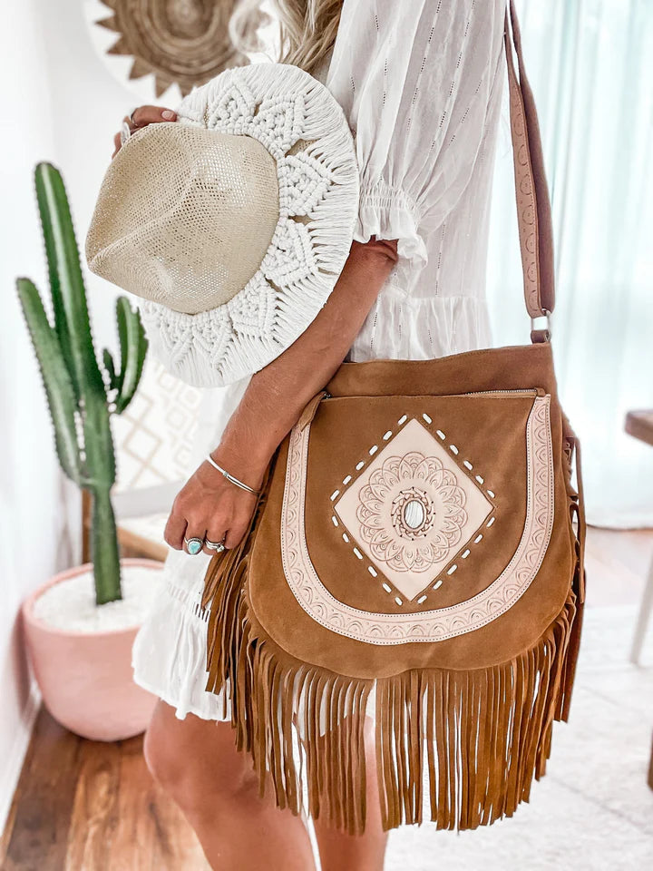 Sahara Spirit Suede Fringe Crossbody Bag in rich brown suede with flowing fringe, a handcrafted tassel, and an adjustable strap
