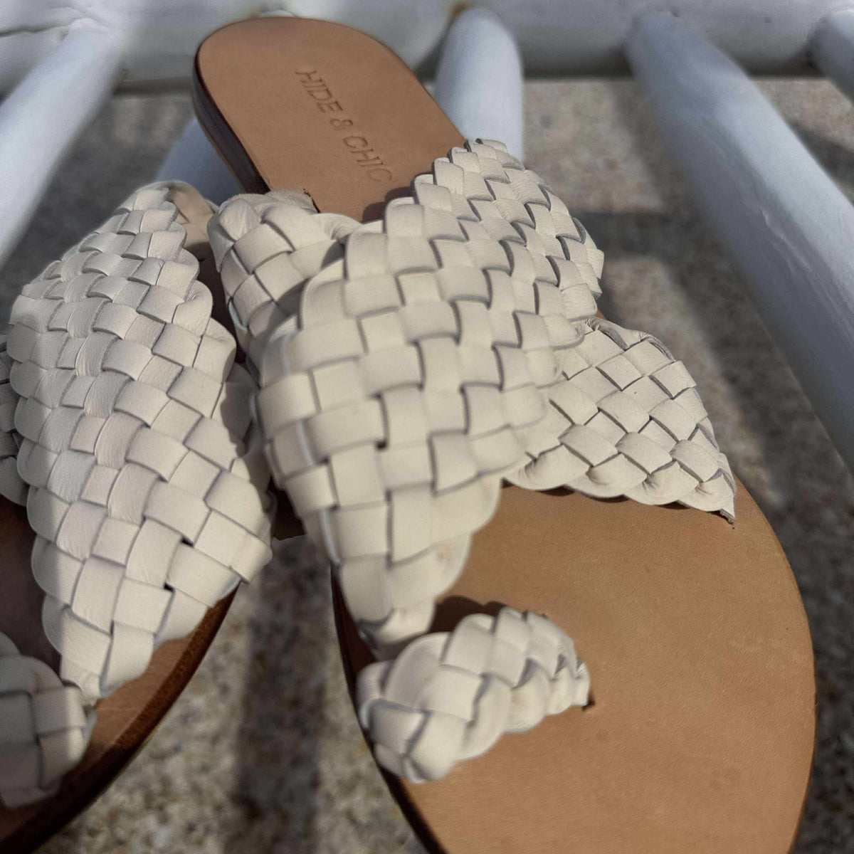 Pair of woven sandals with a blurred background