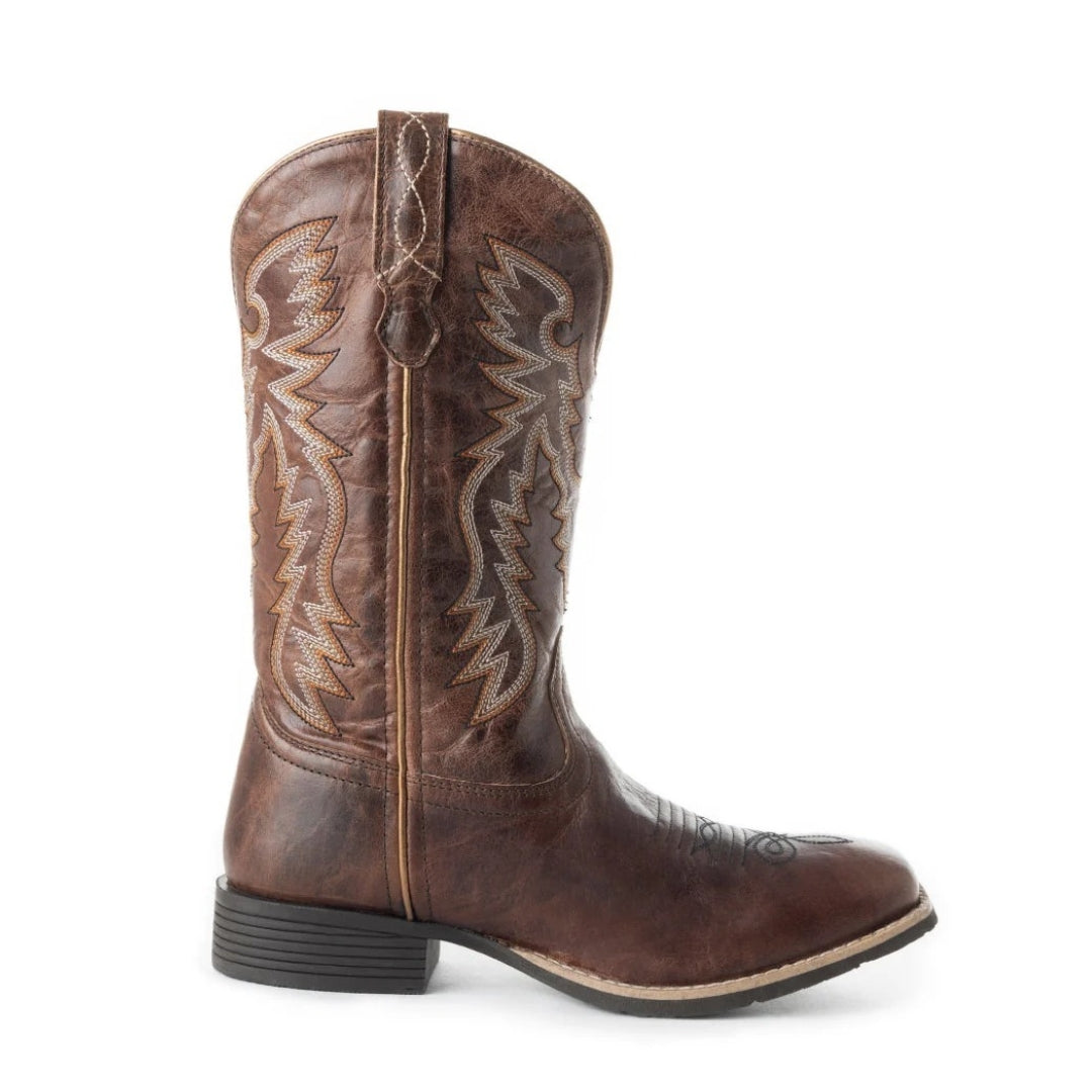 Side view of a Salvage brown leather boot showing wing-style stitching, a pull strap, square toe and low heel.