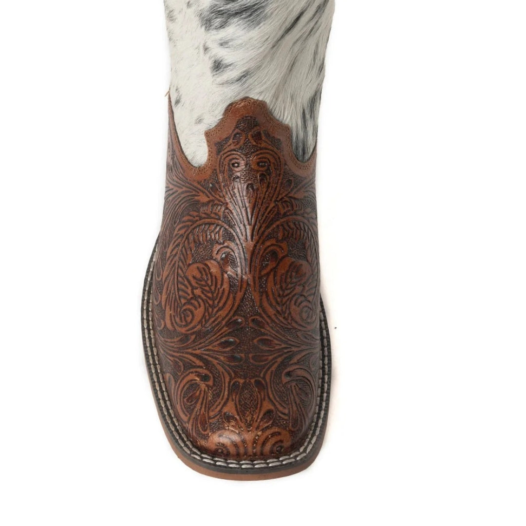 Close-up of the Savanna boot’s square toe, showing floral tooling in brown leather and contrasting sole stitching.