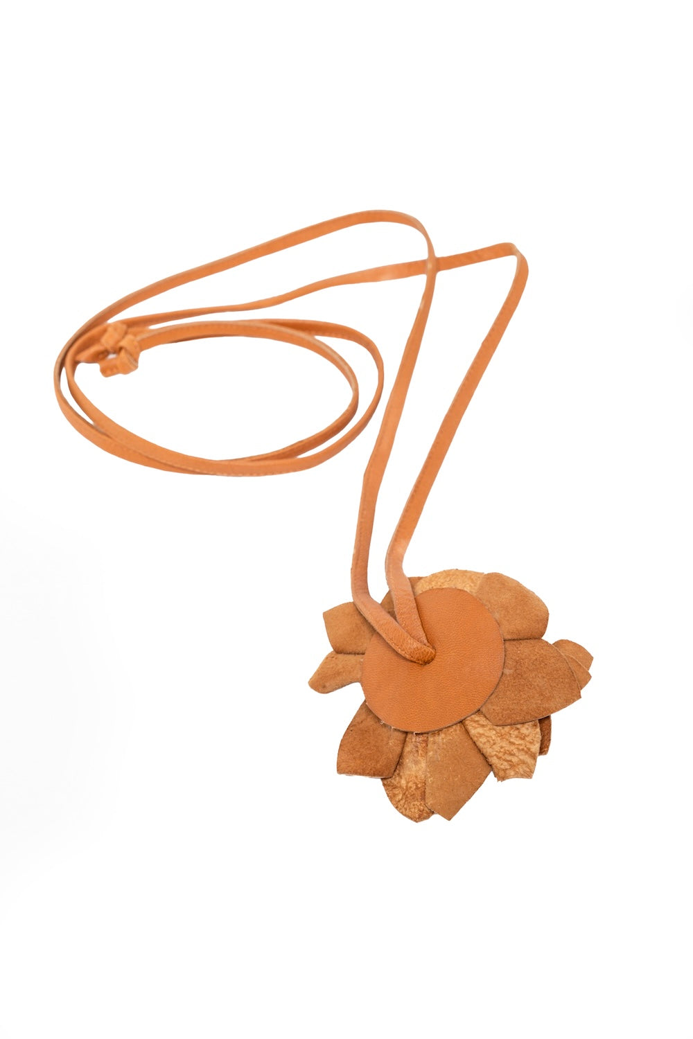 Detailed view of handmade tan leather choker featuring a dimensional flower, tied at the back for a custom fit—styled in a neutral setting.
