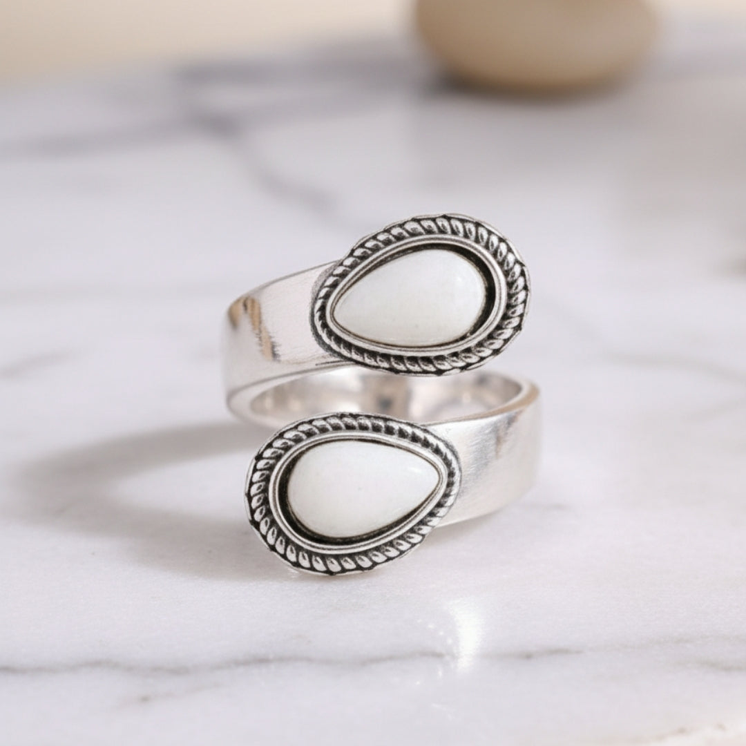 Sea Pearl Mirage Ring displayed on white surface minimalist silver and white stone design