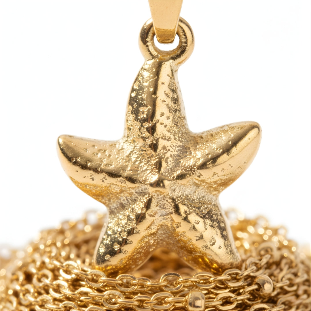 Close-up of the SeaLustre Charm Necklace featuring a textured gold-plated starfish pendant on a beaded chain.
