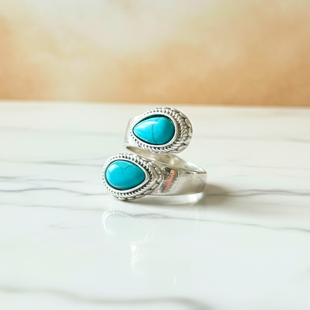 Silver double turquoise stone ring by House of Hide Perth displayed on white surface