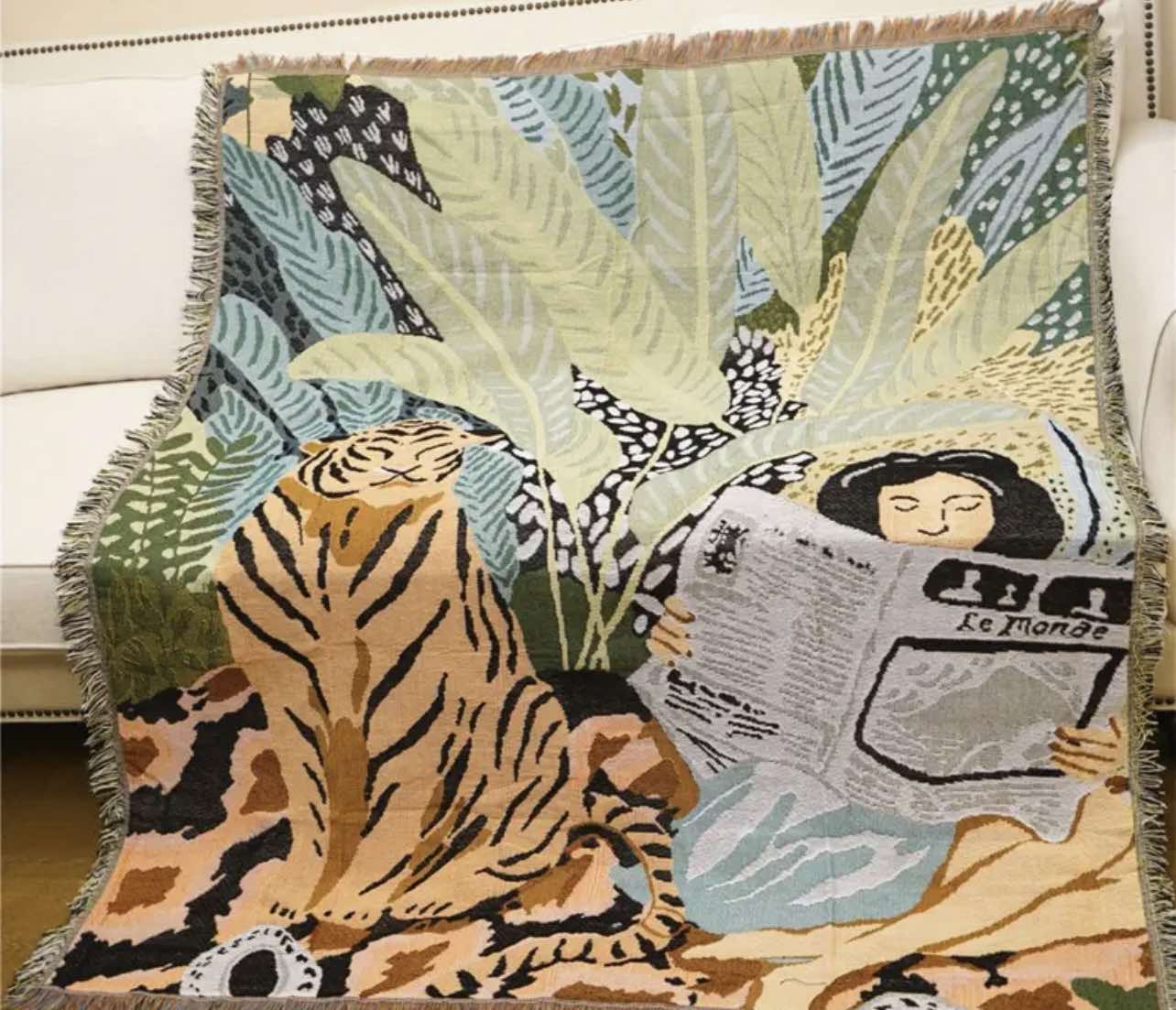 Serenity Forest Throw Blanket draped over a sofa, showcasing its soft texture and forest-inspired pattern.