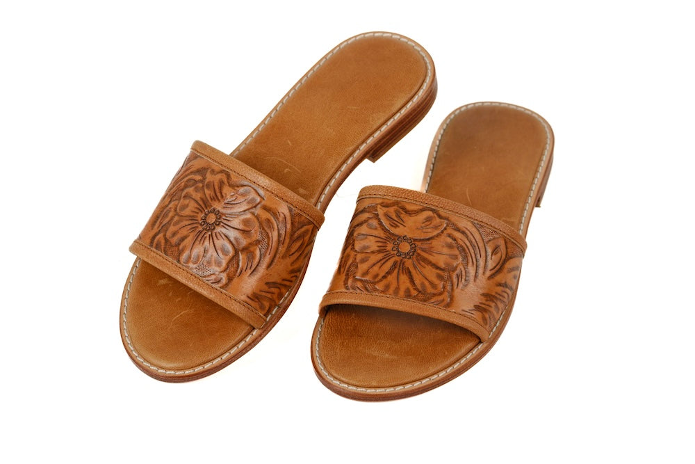 Side profile of Madora Slides showing wide leather strap and flat sole