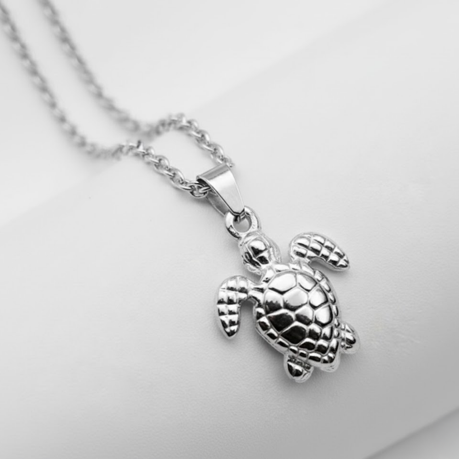 Silver Turtle Necklace Perth Australia Houseofhide handmade stainless steel turtle pendant displayed flatlay