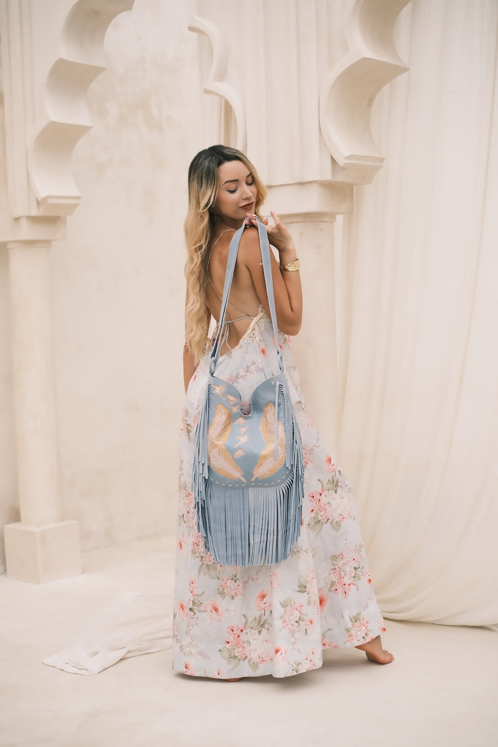 Slow fashion suede bag with fringe, pockets, and magnetic clasp