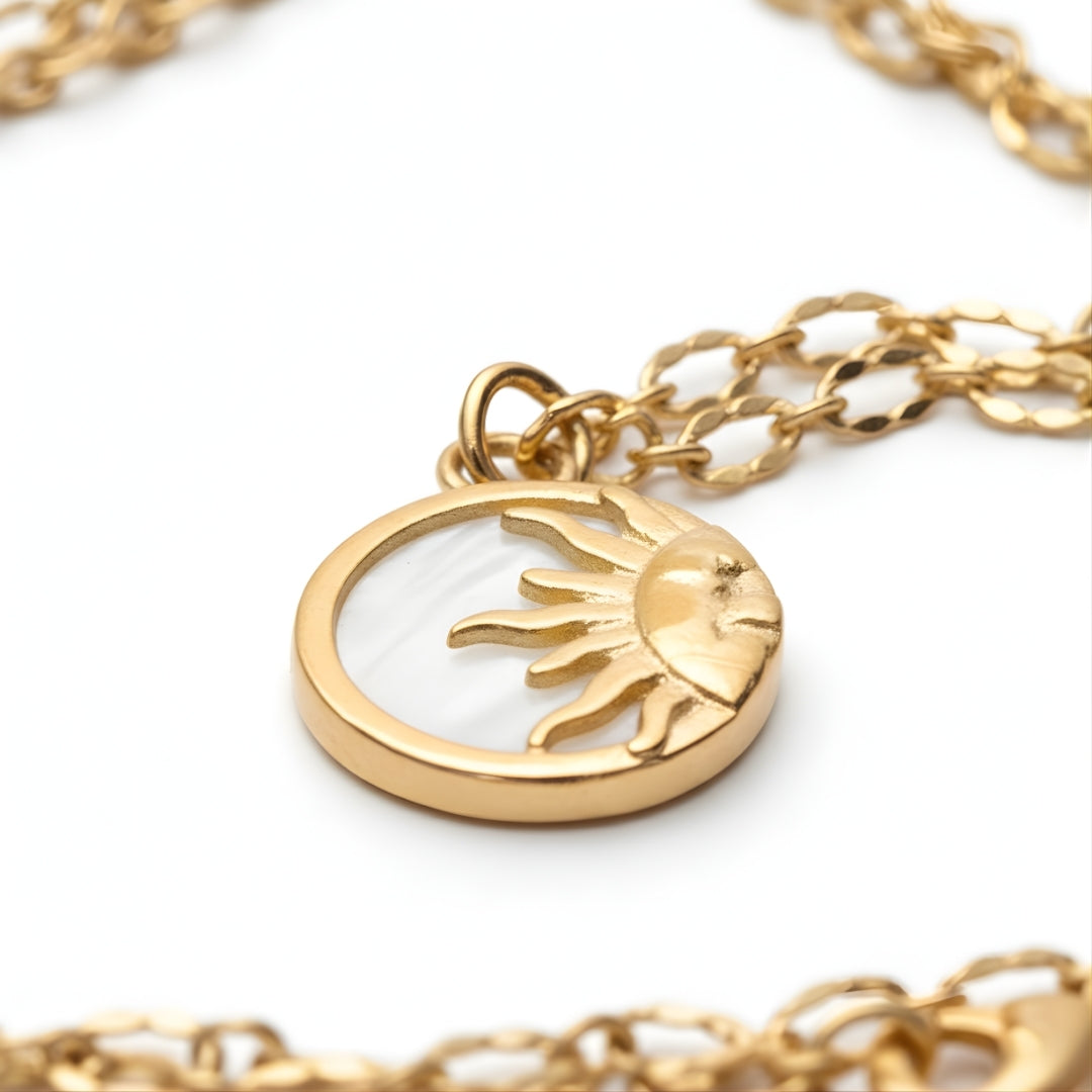 Round gold pendant with engraved sun design from House of Hide Perth jewellery collection