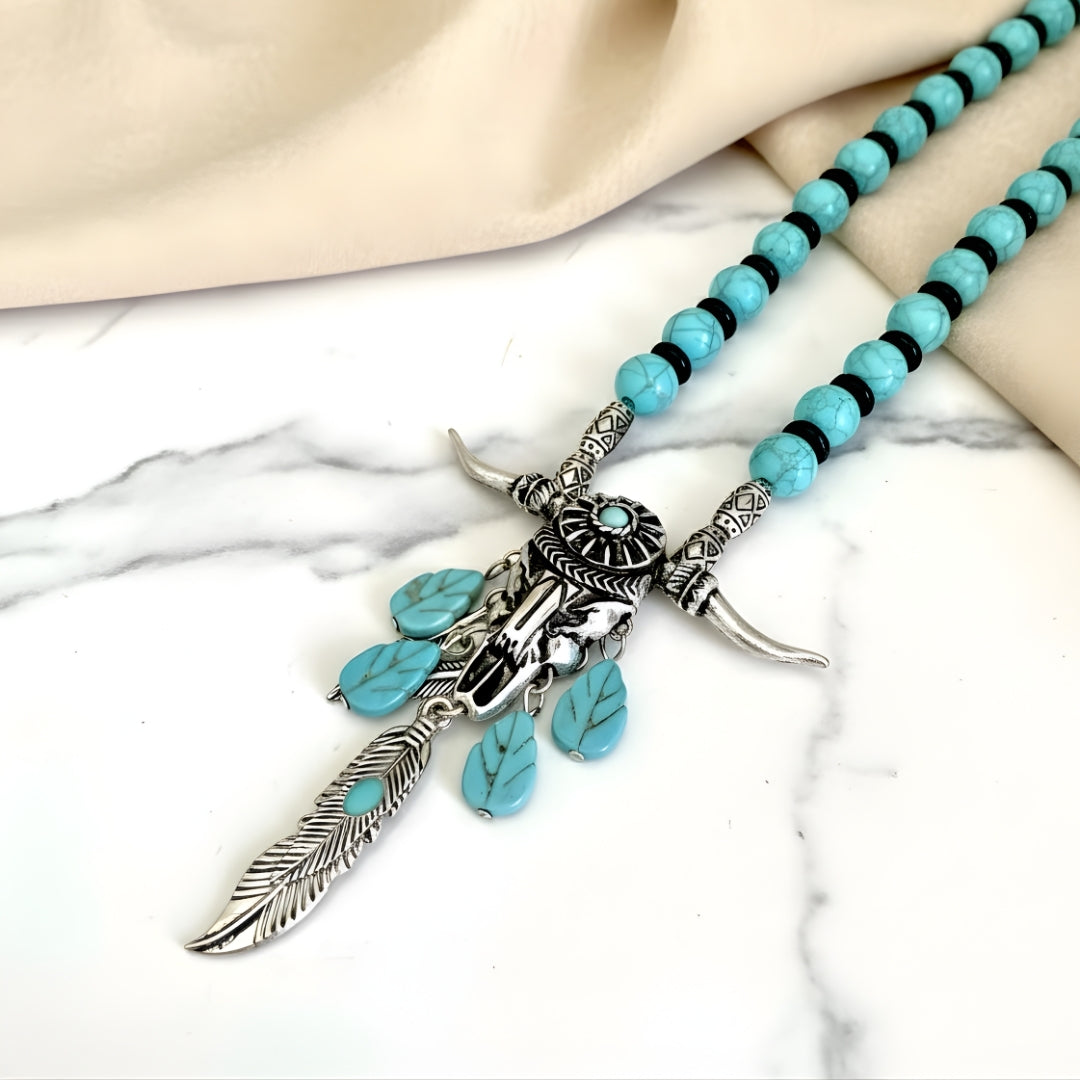 Spirit of the Plains Necklace featuring turquoise beads and silver pendant on white surface