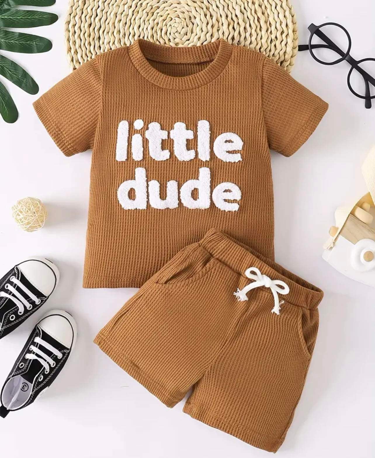 Keep your little one looking adorable and feeling comfortable with our Little Dude Summer Set. Made from a soft waffle cotton blend, this stylish shirt and shorts combo is perfect for warm-weather outings.

