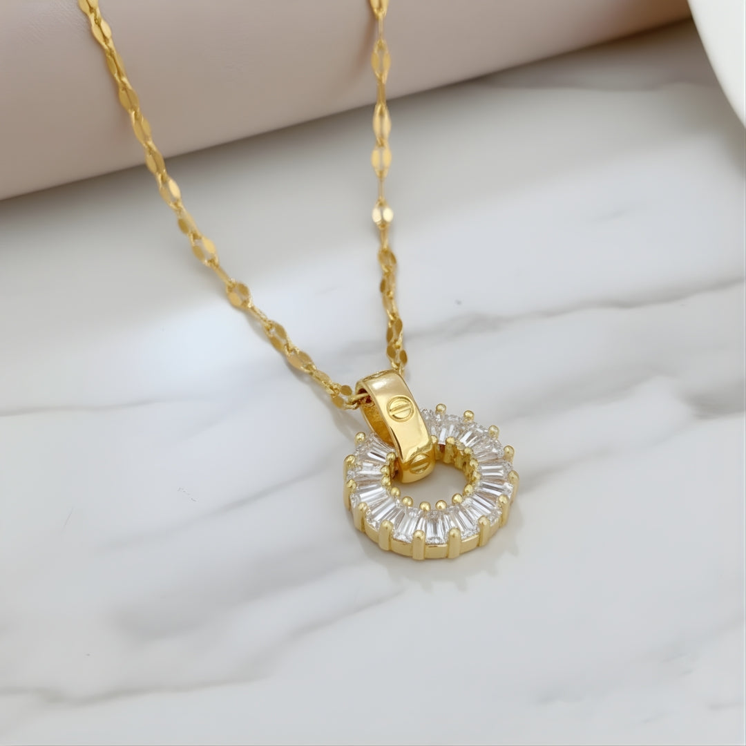 Sunbeam Shores Necklace featuring gold chain with round pendant on white surface