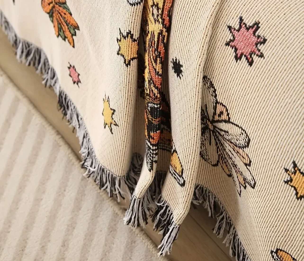 The Western Rodeo Jacquard Throw Blanket used as a bedspread, adding a rustic, western touch to a cosy bedroom.