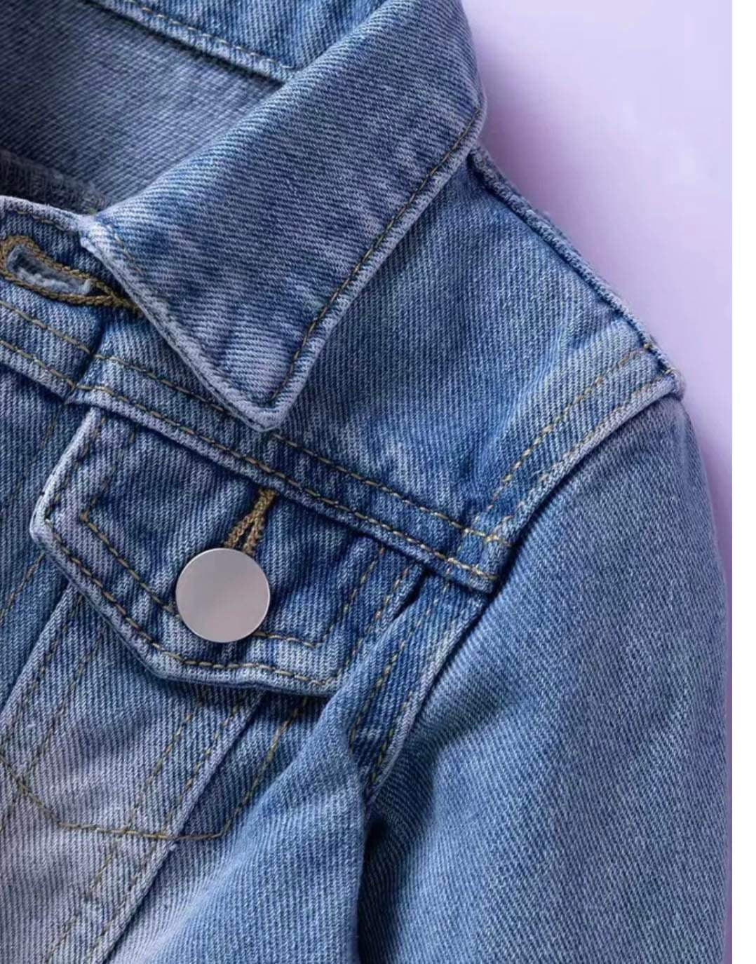 Toddler-sized blue denim jacket with button closures, perfect for layering in all seasons.