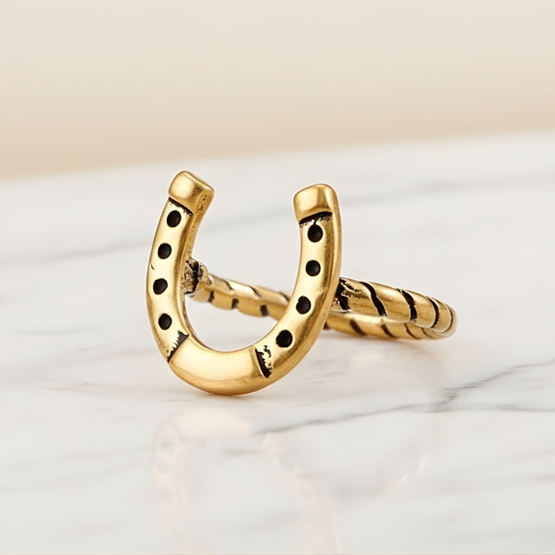 Gold horseshoe ring by House of Hide Perth displayed on clean white surface