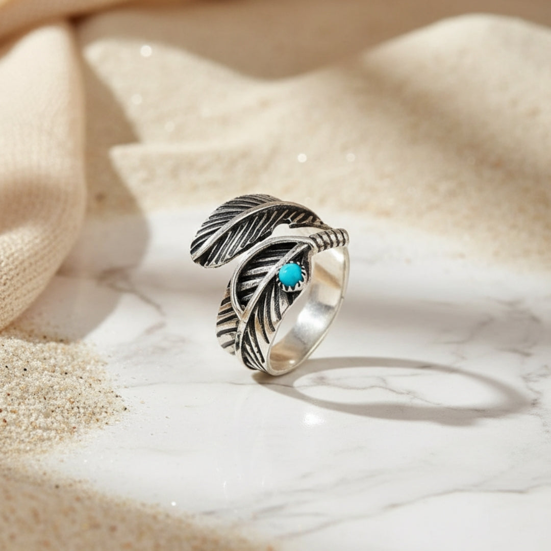 Turquoise Dream Feather Ring displayed on sand surface artisan silver jewellery from Perth Australia