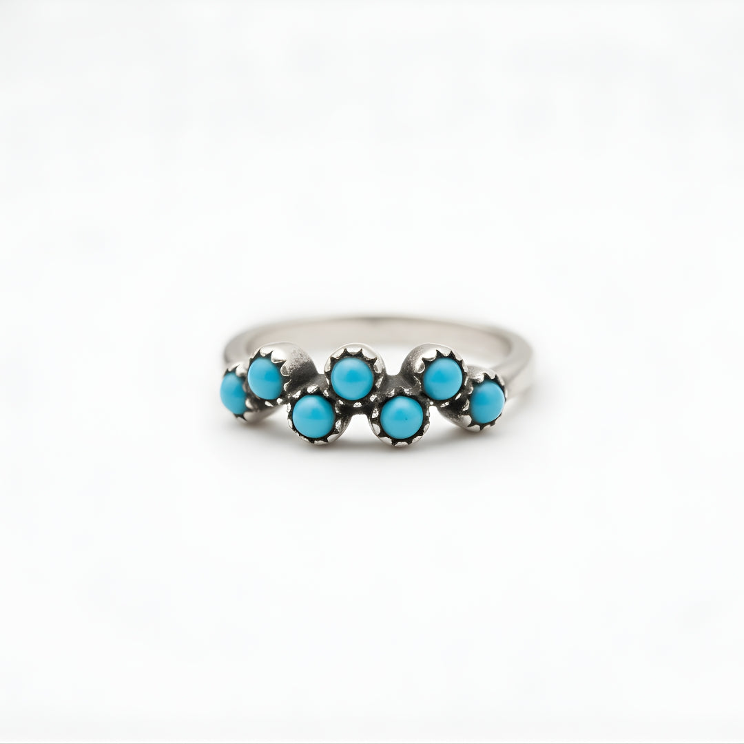 Minimalist product shot of a silver ring with turquoise stones by House of Hide jewellery, Perth, Australia