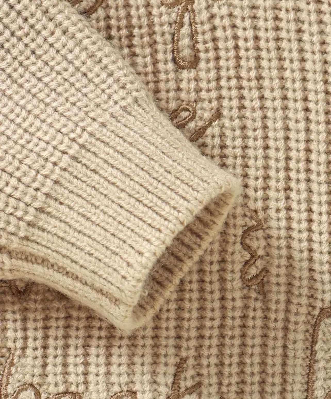 Unisex baby knit romper in warm beige, designed for comfort with breathable cotton, ribbed cuffs, and easy-access bottom buttons—ideal for cozy outfits in all Australian seasons.