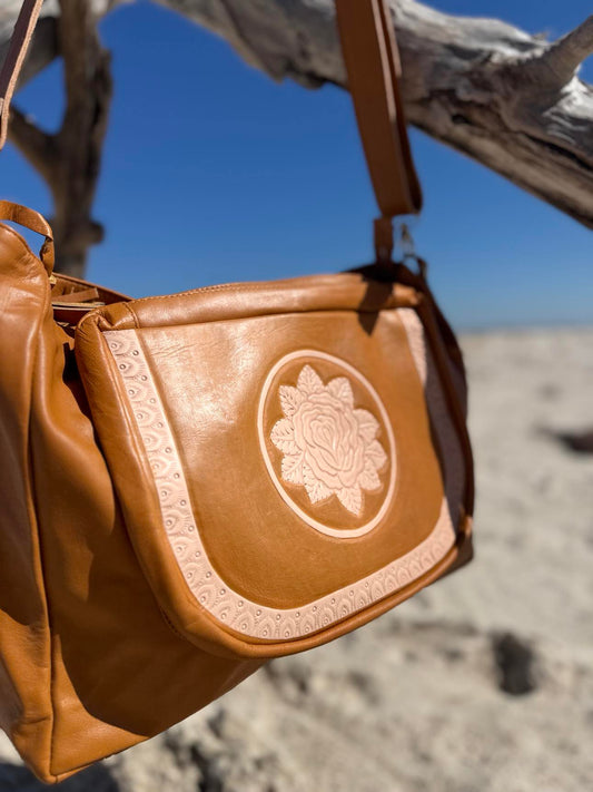 Western-inspired tan leather bag with floral tooling