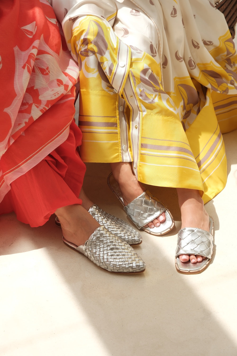 Side view of women’s closed toe flat mules in silver leather featuring a handwoven upper, ideal for summer styling and casual all-day wear