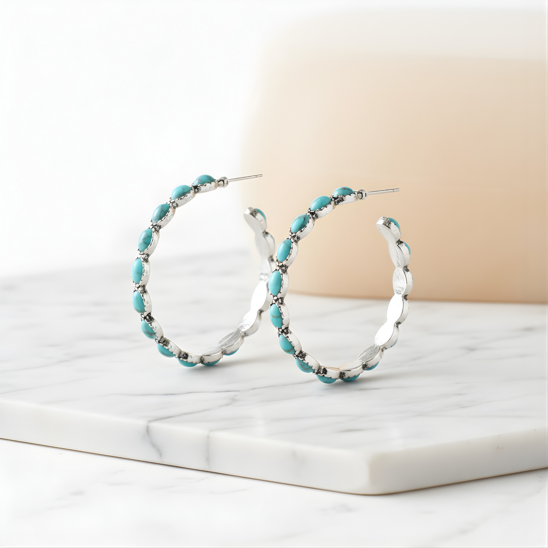 Azure Horizon Earrings featuring turquoise beads on silver hoops on white surface
